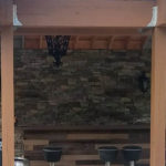 outdoor kitchen area with stone walls